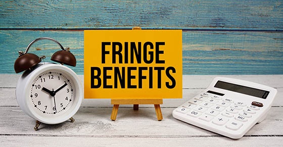 fringe,benefits,text,written,on,paper,card,with,calculator,and